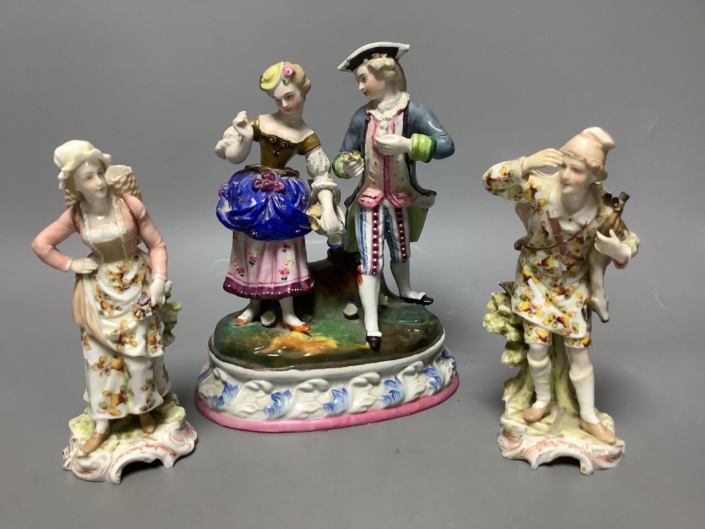 A Continental porcelain group of a couple picking flowers and a similar pair of figures